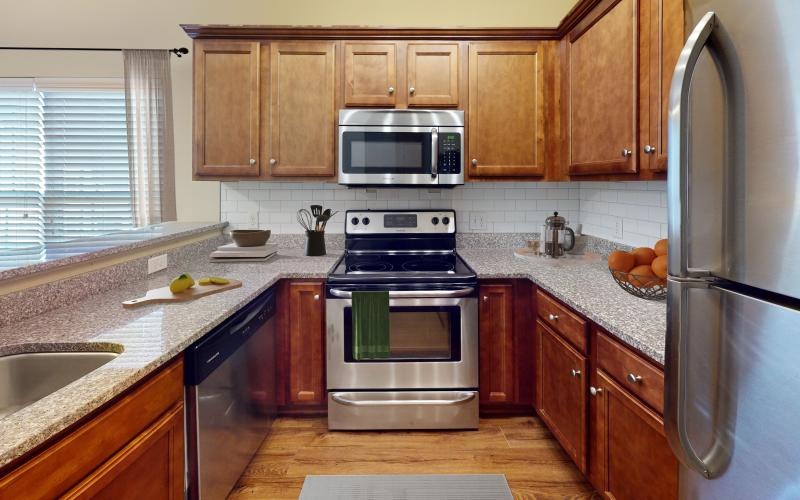 a kitchen with wooden cabinets