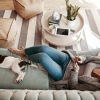 a woman laying down beside a pet
